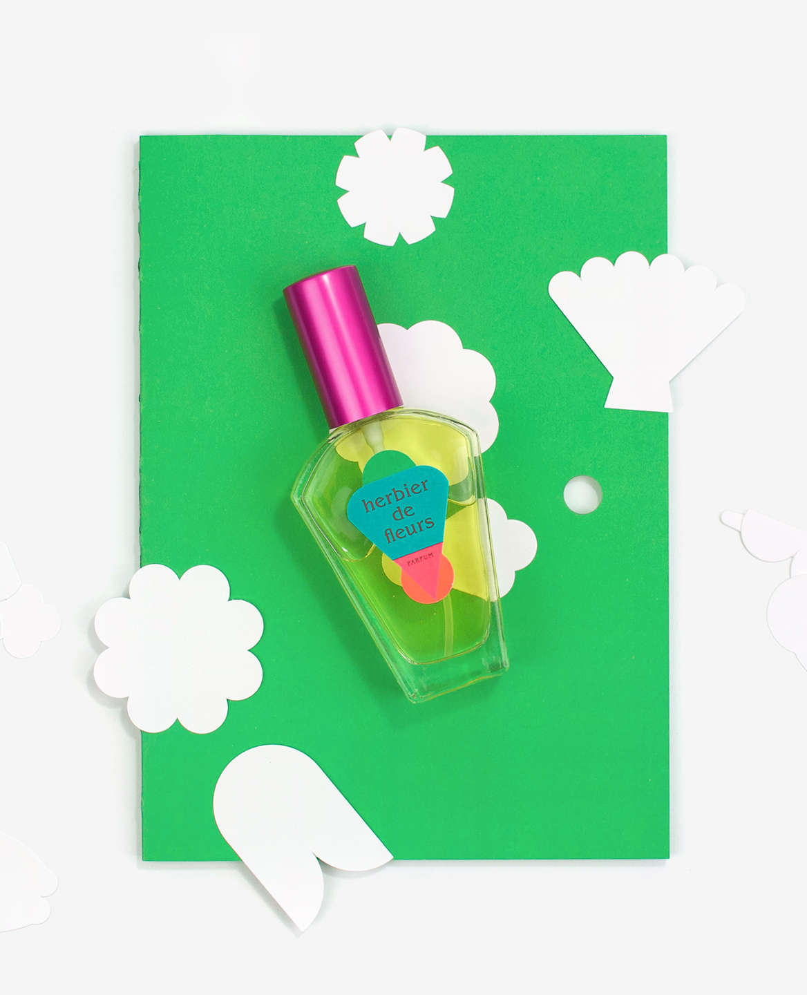 Flacon du parfum Herbier de fleurs posé sur le livre Herbier